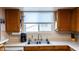 Kitchen countertop featuring wood cabinets, a stainless-steel sink and window at 1213 N Raven --, Mesa, AZ 85207