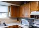 Kitchen featuring wood cabinets, a stainless-steel microwave, and white countertops at 1213 N Raven --, Mesa, AZ 85207