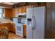 Well-lit kitchen showcasing wooden cabinets and modern white appliances, creating a welcoming culinary environment at 1213 N Raven --, Mesa, AZ 85207