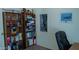 Well-organized office space with bookshelves, a comfortable chair, and decorative wall art at 1213 N Raven --, Mesa, AZ 85207