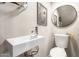 Small bathroom featuring a modern sink and toilet with floral decorations at 1257 N 47Th Pl, Phoenix, AZ 85008