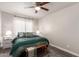 Cozy bedroom with neutral walls, a plush bed, and a ceiling fan at 1257 N 47Th Pl, Phoenix, AZ 85008