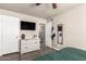 Bedroom with a ceiling fan, a dresser, a mounted television, and two doors at 1257 N 47Th Pl, Phoenix, AZ 85008