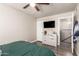 Bedroom with a large bed, a ceiling fan, a dresser, and a television at 1257 N 47Th Pl, Phoenix, AZ 85008