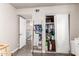 Bedroom view showing a closet, secondary exit, and decoratively placed ladder with towels at 1257 N 47Th Pl, Phoenix, AZ 85008