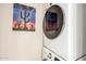 Bright laundry room with a stacked washer and dryer and a colorful cactus print on the wall at 1257 N 47Th Pl, Phoenix, AZ 85008