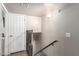 Basement stairway with handrail, neutral decor, and a door on the landing at 1257 N 47Th Pl, Phoenix, AZ 85008