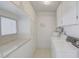 Convenient laundry room offering built-in storage cabinets and a window at 12887 N 99Th Dr, Sun City, AZ 85351