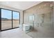 Modern bathroom features soaking tub, shower with glass door, and outdoor views at 13116 E Desert Holly Dr, Scottsdale, AZ 85255