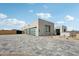 Contemporary home boasts a gray brick driveway leading to a modern glass-door garage and minimalist desert landscaping at 13116 E Desert Holly Dr, Scottsdale, AZ 85255