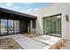 Charming patio area featuring modern desert landscaping, sleek black accents, and beautiful natural light at 13116 E Desert Holly Dr, Scottsdale, AZ 85255