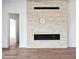 Close-up of modern fireplace with sleek design and stone surround, complemented by stylish hardwood flooring at 13116 E Desert Holly Dr, Scottsdale, AZ 85255