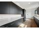 Modern kitchen with sleek gray cabinets, marble countertops, and stainless steel appliances at 13116 E Desert Holly Dr, Scottsdale, AZ 85255