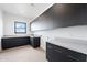 Laundry room with custom cabinets, sink, and window at 13116 E Desert Holly Dr, Scottsdale, AZ 85255