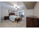 Comfortable bedroom with carpet flooring, ceiling fan, and a view into the dining room at 13251 W Aleppo Dr, Sun City West, AZ 85375