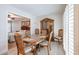 Cozy dining room with wood table, hutch, and view into bedroom for a open and inviting atmosphere at 13251 W Aleppo Dr, Sun City West, AZ 85375