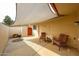 Relaxing covered patio area featuring comfortable seating, ideal for enjoying the outdoor space at 13251 W Aleppo Dr, Sun City West, AZ 85375