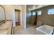 Bathroom with a walk-in glass shower, a bathtub, and a double sink vanity at 13278 E Buckskin Trl, Scottsdale, AZ 85255