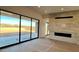 Bright living room with a fireplace and sliding glass doors that offer a view of the backyard at 13278 E Buckskin Trl, Scottsdale, AZ 85255