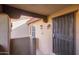 Private condo entrance with security door, tan stucco walls, and a covered ceiling at 1351 N Pleasant Dr # 2030, Chandler, AZ 85225