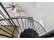 View of the entryway and spiral staircase with gray tile and access to the outdoor space from the second floor at 1351 N Pleasant Dr # 2030, Chandler, AZ 85225