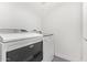 Modern laundry room features gray tile and updated appliances at 1351 N Pleasant Dr # 2030, Chandler, AZ 85225