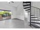 Living room featuring spiral staircase, sliding doors to a balcony, and modern gray-scale finishes at 1351 N Pleasant Dr # 2030, Chandler, AZ 85225