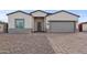 Charming stucco home with a two-car garage and patterned brick driveway at 14240 S Overfield Rd, Arizona City, AZ 85123