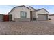 Charming stucco home with a two-car garage and patterned brick driveway at 14240 S Overfield Rd, Arizona City, AZ 85123