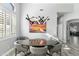 Modern dining room featuring unique light fixture, gray walls, and a round dining table with seating at 14442 N Prickly Pear Ct, Fountain Hills, AZ 85268