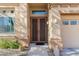 Close-up of a home's entrance with decorative double doors and manicured desert landscaping at 14442 N Prickly Pear Ct, Fountain Hills, AZ 85268