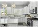 Well-lit kitchen featuring marble countertops, white cabinets, and stainless steel appliances at 14442 N Prickly Pear Ct, Fountain Hills, AZ 85268