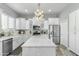 Spacious white kitchen featuring marble countertops, stainless steel appliances, and modern lighting at 14442 N Prickly Pear Ct, Fountain Hills, AZ 85268