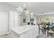 Bright kitchen with marble island, white cabinets, and elegant chandeliers, perfect for cooking and entertaining at 14442 N Prickly Pear Ct, Fountain Hills, AZ 85268