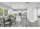 Charming white kitchen featuring stainless appliances, island, and breakfast nook with bright natural light from shuttered windows at 14442 N Prickly Pear Ct, Fountain Hills, AZ 85268