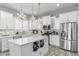 Bright kitchen with white cabinets, marble countertops, stainless steel appliances, and chandeliers at 14442 N Prickly Pear Ct, Fountain Hills, AZ 85268