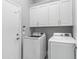 Laundry room featuring overhead cabinets and a white washer and dryer set at 14442 N Prickly Pear Ct, Fountain Hills, AZ 85268