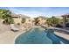 Stunning backyard with pool, rock waterfall, patio, and desert landscaping; ideal for relaxing and enjoying the outdoors at 14442 N Prickly Pear Ct, Fountain Hills, AZ 85268