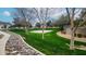 Community basketball court surrounded by green grass and mature trees at 14870 W Encanto Blvd # 2069, Goodyear, AZ 85395