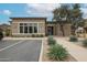 Community clubhouse showcasing modern architecture, landscaped grounds, and reserved parking spaces at 14870 W Encanto Blvd # 2069, Goodyear, AZ 85395