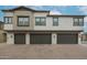 Attractive three-story townhome featuring private garages and tasteful exterior color palette at 14870 W Encanto Blvd # 2069, Goodyear, AZ 85395