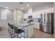 Beautiful kitchen with stainless steel appliances, island seating and bright white cabinets at 14870 W Encanto Blvd # 2069, Goodyear, AZ 85395