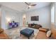 Cozy living room featuring a leather sofa, modern ceiling fan, and an entertainment center at 14870 W Encanto Blvd # 2069, Goodyear, AZ 85395