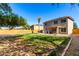 View of backyard with manicured lawn, gravel landscaping, and two story home at 14970 N 172Nd Dr, Surprise, AZ 85388