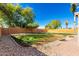 Spacious backyard with a mix of grass, gravel, and brick landscaping at 14970 N 172Nd Dr, Surprise, AZ 85388