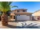 Two story home with a two car garage, desert landscaping and tiled roof under a clear blue sky at 14970 N 172Nd Dr, Surprise, AZ 85388