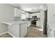 Modern kitchen with white cabinetry, stainless steel appliances, a tile backsplash, and a breakfast bar at 14970 N 172Nd Dr, Surprise, AZ 85388