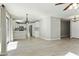 Spacious living room showing tile flooring, decorative lighting, and access to the kitchen at 14970 N 172Nd Dr, Surprise, AZ 85388