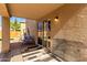 View of covered patio with textured concrete, a swing, and a wire animal kennel at 14970 N 172Nd Dr, Surprise, AZ 85388