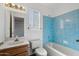 Bathroom showcasing blue shower tiles, a wood vanity, toilet, and a large mirror at 15834 E Sunflower Dr # 1, Fountain Hills, AZ 85268